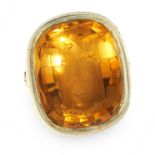 AN ANTIQUE CARVED CITRINE INTAGLIO SEAL / SIGNET RING in yellow gold, set with a large cushion cut