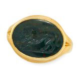 A CARVED BLOODSTONE INTAGLIO SEAL RING in high carat yellow gold, the face set with an oval piece of