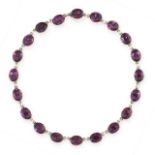 AN ANTIQUE PASTE AMETHYST RIVIERE NECKLACE in silver, comprising a single row of twenty oval cut