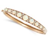 AN ANTIQUE OPAL AND DIAMOND BANGLE in yellow gold, the tapering body set with nine graduated round