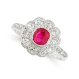 A RUBY AND DIAMOND DRESS RING set with a cushion cut ruby within a border of old cut diamonds,