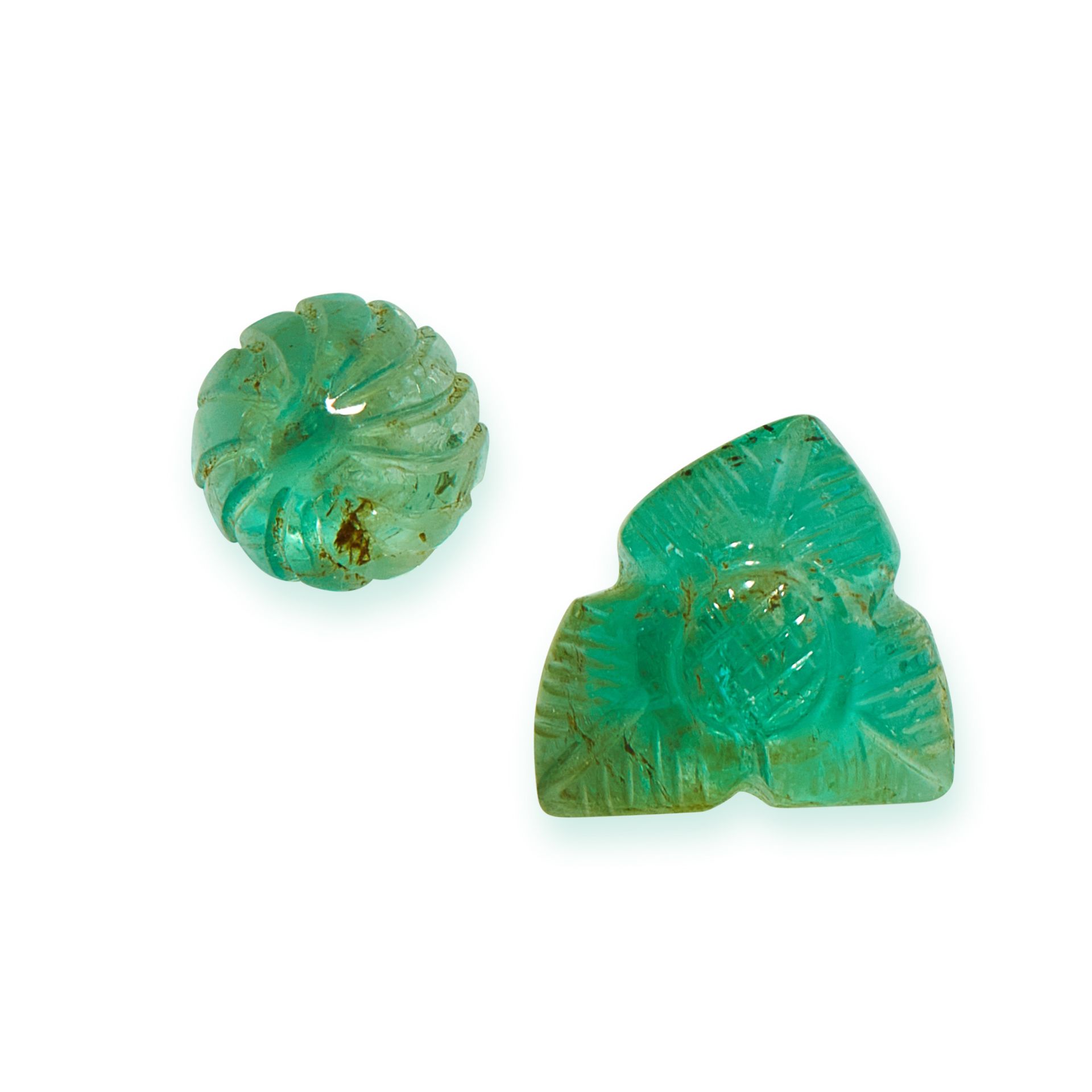 TWO UNMOUNTED EMERALDS Mughal carved with foliate designs, totalling 7.34 carats.