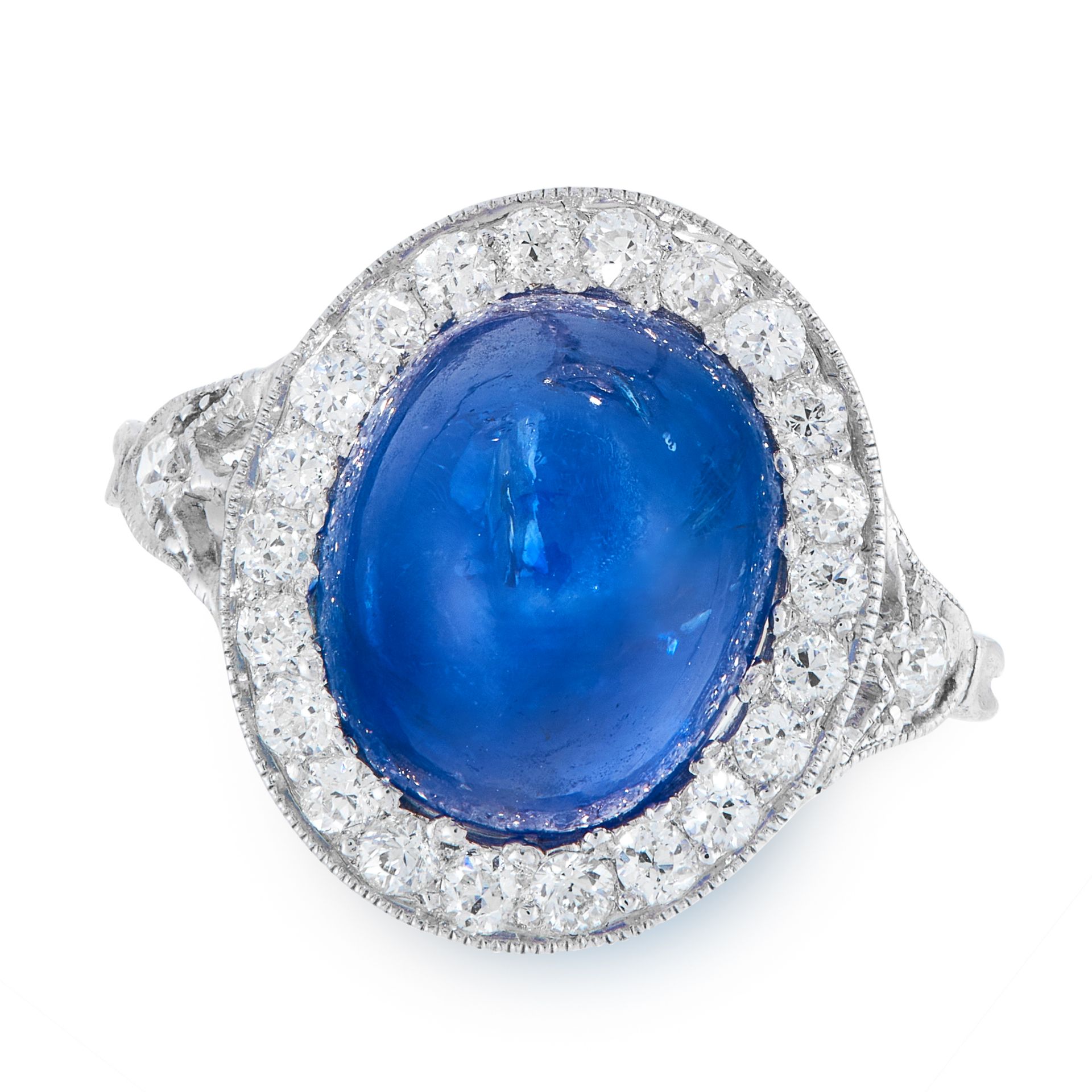 A SAPPHIRE AND DIAMOND DRESS RING in platinum, set with an oval cabochon blue sapphire of 8.49