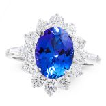 A TANZANITE AND DIAMOND DRESS RING in 18ct white gold, set with an oval cut tanzanite of 3.66