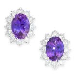 A PAIR OF TANZANITE AND DIAMOND STUD EARRINGS in 18ct white gold, each set with an oval cut