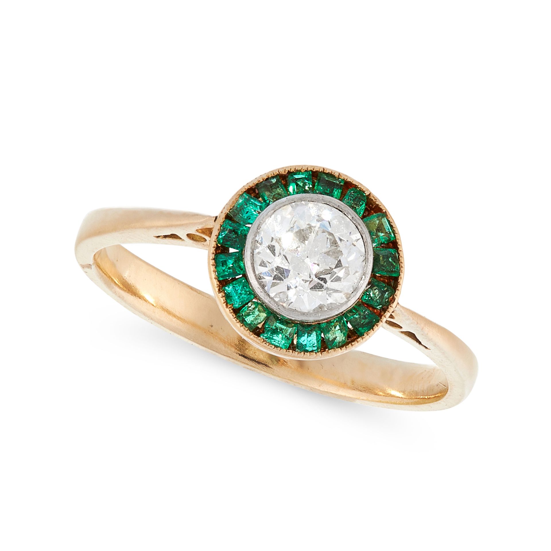 A DIAMOND AND EMERALD DRESS RING in high carat yellow gold, in target design, set with a central old