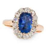 A BURMA NO HEAT SAPPHIRE AND DIAMOND CLUSTER RING in yellow gold, set with a cushion cut sapphire of