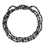 A VINTAGE BEAD NECKLACE comprising a single row of round and elongated faceted black beads, 143.0cm,