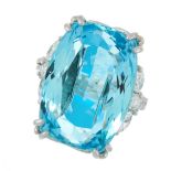 AN AQUAMARINE AND DIAMOND DRESS RING in platinum, set with a cushion cut aquamarine of 22.03 carats,