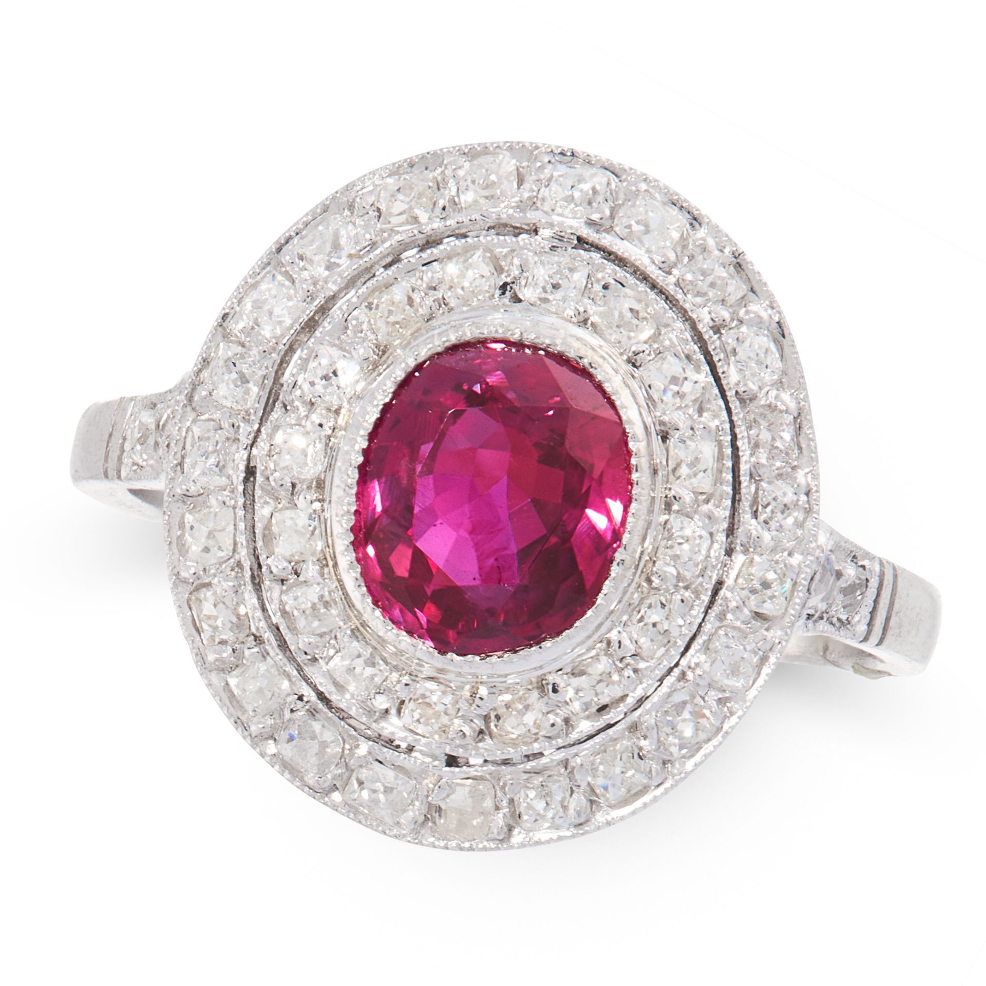 A RUBY AND DIAMOND DRESS RING in platinum, set with an oval cut ruby of 1.23 carats within a