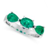 AN EMERALD DRESS RING in 18ct white gold, set with a trio of oval cut and pear cut emeralds, stamped