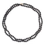 A VINTAGE BEAD NECKLACE comprising a single row of faceted black beads, 104.0cm, 52.8g.