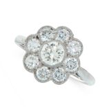 A DIAMOND CLUSTER DRESS RING set with a central round cut diamond within a border of eight further