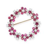 A RUBY AND DIAMOND BROOCH designed as a circular wreath of flowers set with clusters of round cut