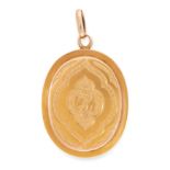AN ANTIQUE MOURNING LOCKET PENDANT in yellow gold, the oval hinged body with engraved foliate