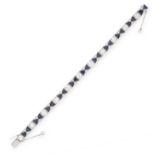 AN ART DECO SAPPHIRE AND DIAMOND BRACELET in platinum, set with a row of eleven principal old