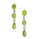 A PAIR OF PERIDOT AND DIAMOND EARRINGS in yellow gold and silver, each set with a trio of emerald