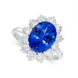 A TANZANITE AND DIAMOND DRESS RING in 18ct white gold, set with an oval cut tanzanite of 4.54