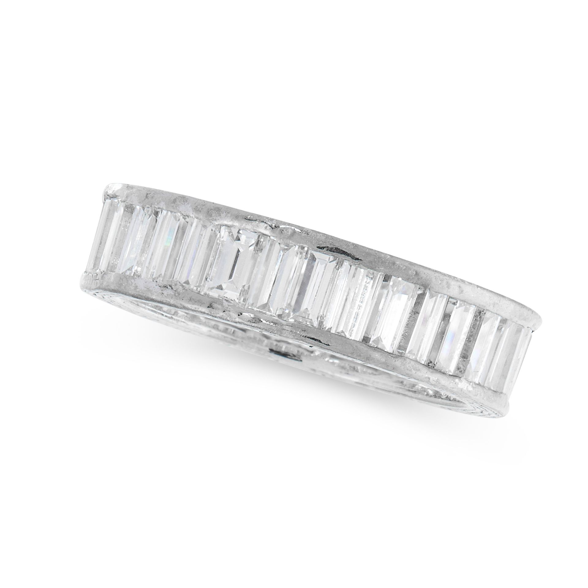 A DIAMOND ETERNITY BAND RING set all around with a single row of baguette cut diamonds, the diamonds