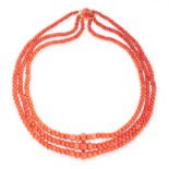 A CORAL BEAD NECKLACE in 18ct yellow gold, comprising three rows of graduated coral beads ranging