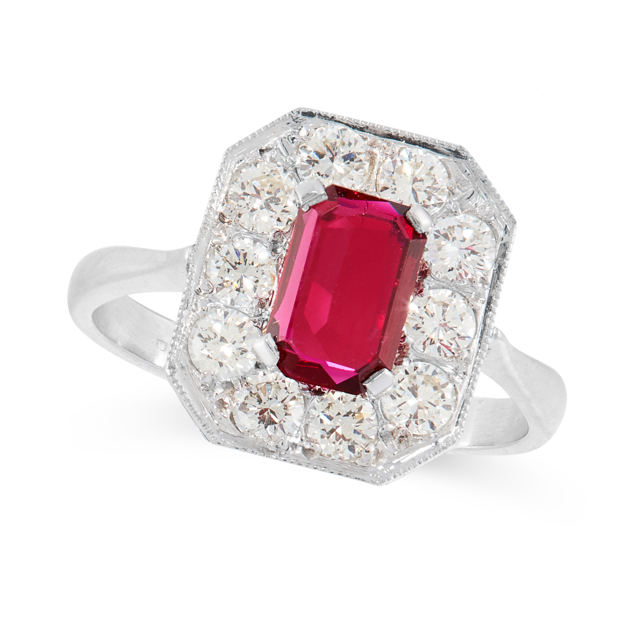 A RUBY AND DIAMOND DRESS RING in platinum, set with an emerald cut ruby of 0.85 carats, within a