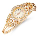 A DIAMOND WATCH BANGLE, EARLY 20TH CENTURY in high carat yellow gold, the circular face within a