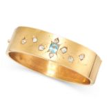 AN ANTIQUE AQUAMARINE AND DIAMOND BANGLE in yellow gold, set with an oval cut aquamarine and eight