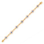 A SAPPHIRE AND DIAMOND BRACELET in 18ct yellow gold, set with seven oval cut blue sapphires
