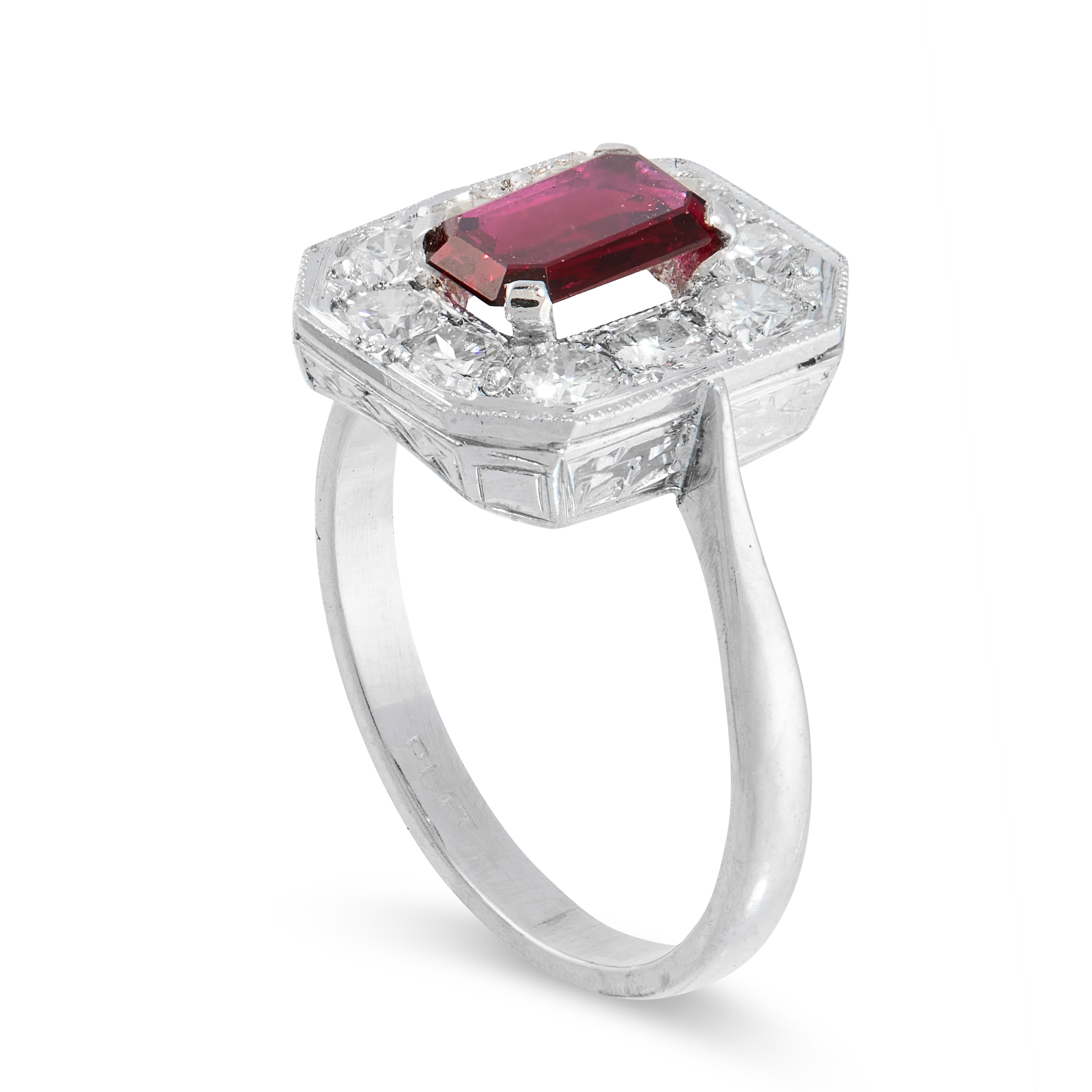 A RUBY AND DIAMOND DRESS RING in platinum, set with an emerald cut ruby of 0.85 carats, within a - Image 2 of 2