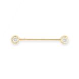 A DIAMOND BARBELL PIERCING, 1960s in yellow gold, terminated at each end with a round cut diamond,