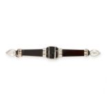 AN ART DECO ONYX AND DIAMOND BROOCH, EARLY 20TH CENTURY designed as a tapering bar, set with