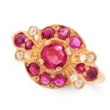 A RUBY AND DIAMOND RING set with a central round cut ruby, accented by round cut rubies and round