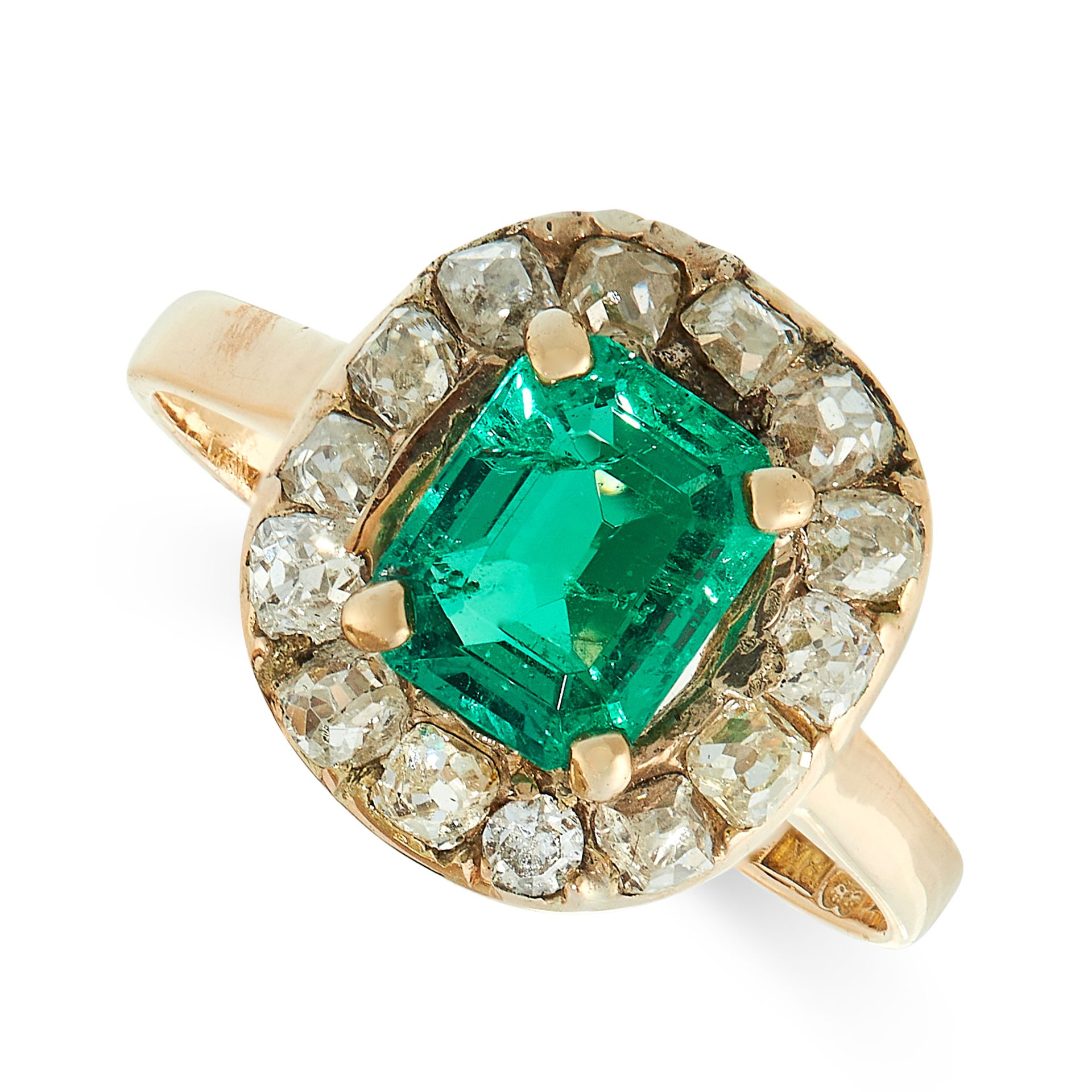 EMERALD AND DIAMOND RING of cluster design, set with a step-cut emerald estimated to weigh