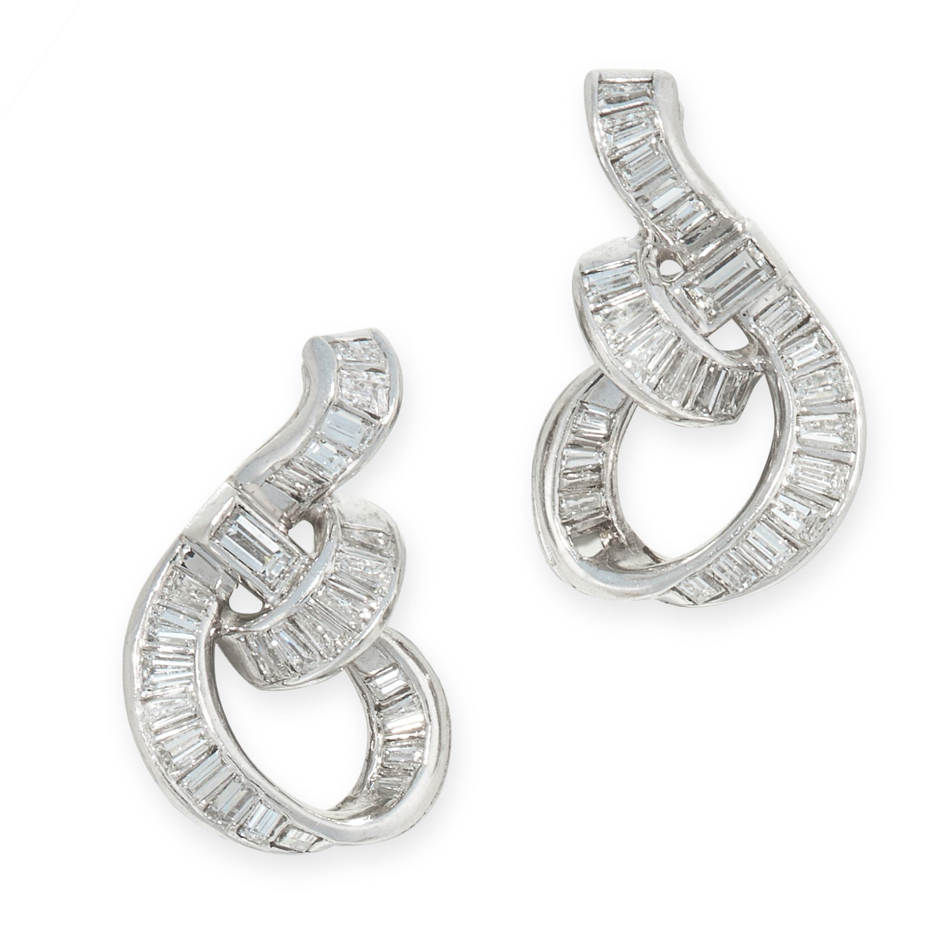 PAIR OF DIAMOND EAR CLIPS each of ribbon scroll design, set with baguette diamonds, clip fittings,