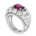 RUBY AND DIAMOND RING claw-set with an oval ruby weighing 2.40 carats, within a bombe mount set to
