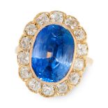 A CEYLON NO HEAT SAPPHIRE AND DIAMOND DRESS RING in 18ct yellow gold, set with a cushion cut blue