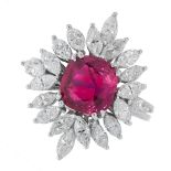 UNHEATED RUBY AND DIAMOND RING in cluster design, set with a cushion cut ruby of 2.93 carats in a