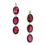 PAIR OF ANTIQUE GARNET EARRINGS in yellow gold, each comprising of three bezel set oval cut garnets,