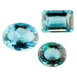 THREE UNMOUNTED BLUE GEMSTONES of oval and emerald cut, totalling 72.03 carats.