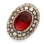 AN ANTIQUE GARNET AND DIAMOND RING in yellow gold and silver, set with an oval cabochon garnet