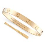 A LOVE BANGLE, CARTIER in 18ct yellow gold, the two-part bangle with screw head motifs, opening