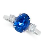 SAPPHIRE AND DIAMOND RING in 18ct set with a cushion cut sapphire of 3.67 carats, between
