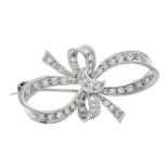 VINTAGE DIAMOND BROOCH designed as a ribbon tied in a bow, set with single cut diamonds, unmarked,