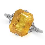 YELLOW SAPPHIRE AND DIAMOND RING comprising of an emerald cut yellow sapphire of 7.03 carats