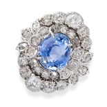 A CEYLON NO HEAT SAPPHIRE AND DIAMOND RING in cluster design, set with an oval cut sapphire of 4.