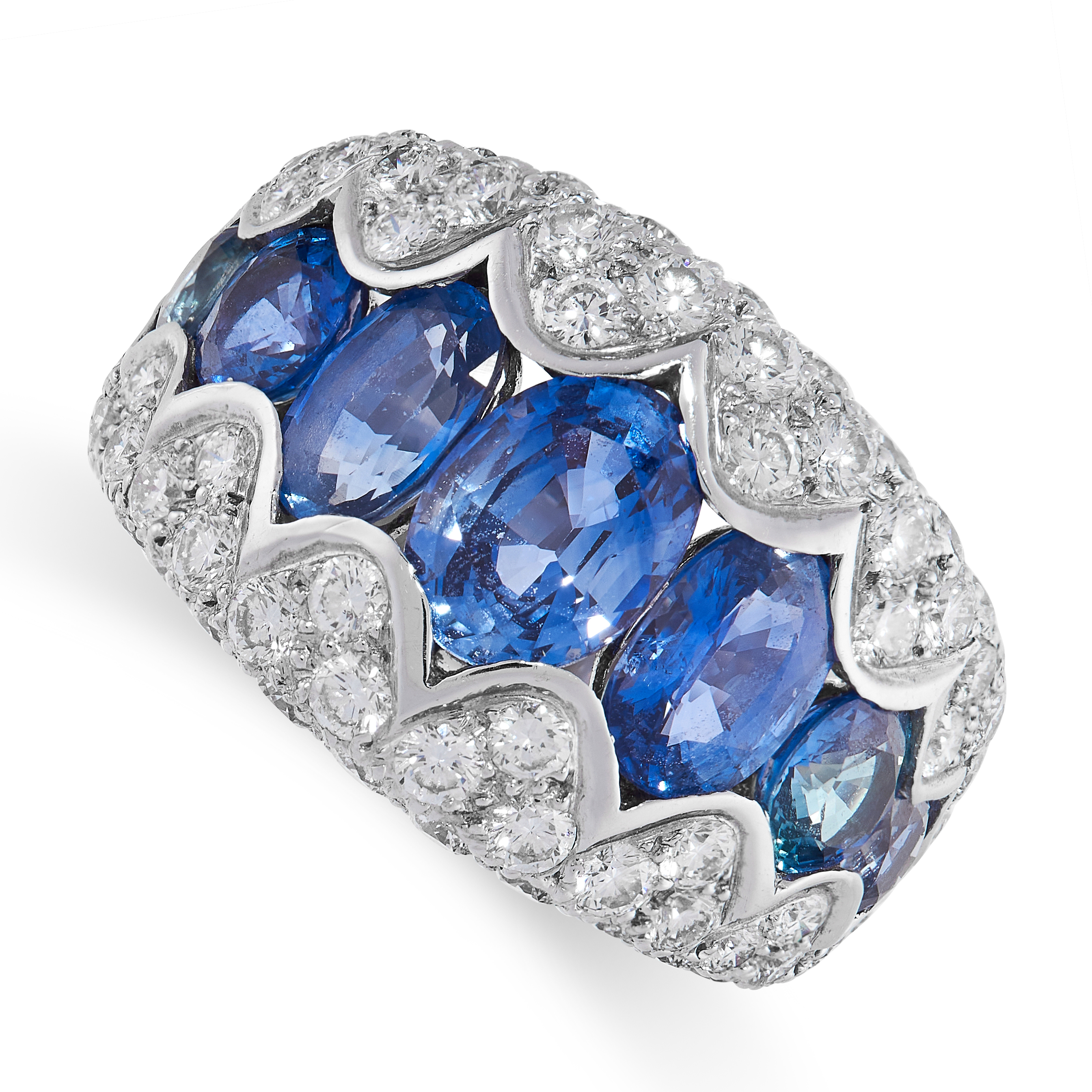 A SAPPHIRE AND DIAMOND RING in 18ct white gold, set with a row of graduated oval cut sapphires,