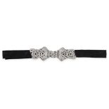 AN ART DECO DIAMOND BOW CHOKER NECKLACE in platinum, designed as a bow with openwork foliate design,
