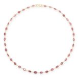 A GARNET CHAIN NECKLACE in yellow gold, comprising of a single row of oval cut garnets between