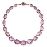 AN ANTIQUE AMETHYST RIVIERE NECKLACE, 19TH CENTURY in yellow gold, formed of twenty graduated oval