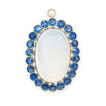 A FINE CARVED MOONSTONE CAMEO AND SAPPHIRE PENDANT set to the centre with an oval moonstone,